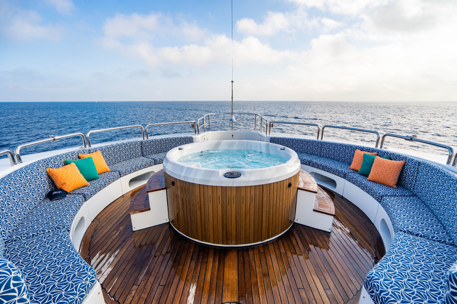 Jacuzzi and wraparound sundeck lounge at sea