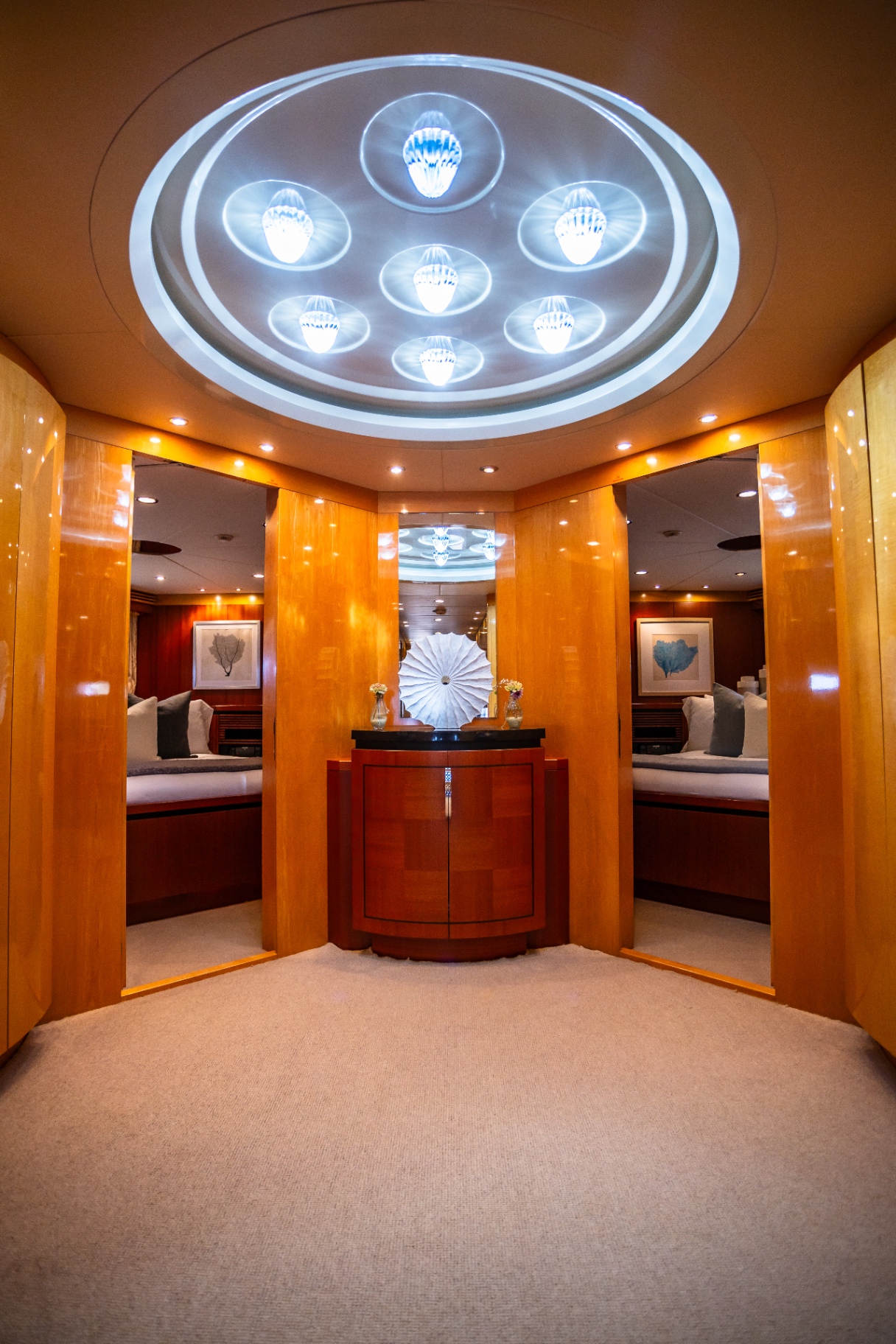 Illuminated foyer with mirrored stateroom entries